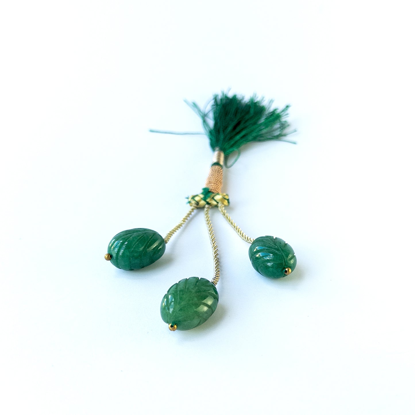 Handmade jewellery components featuring natural emerald carved oval beads in a matched trio.