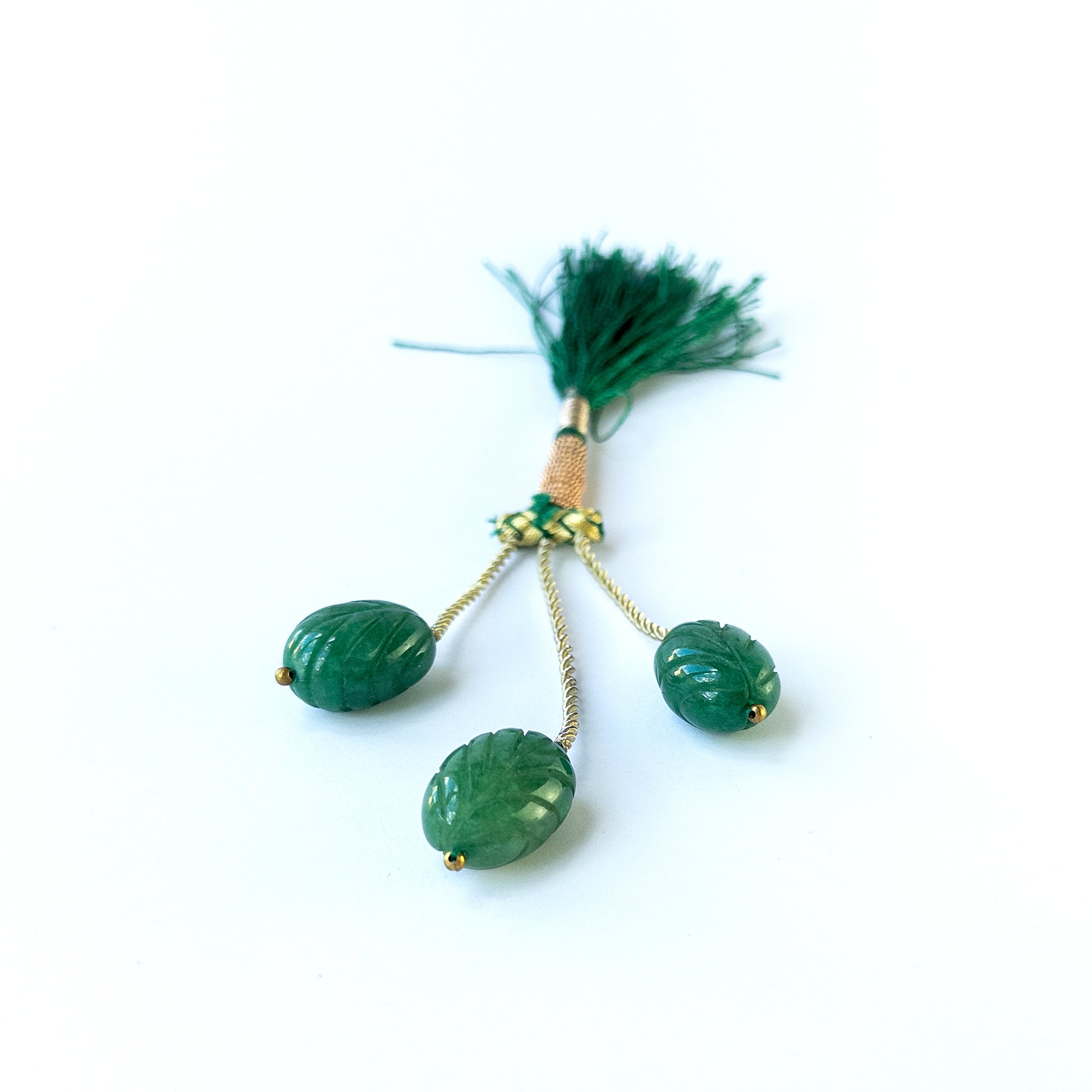 Handmade jewellery components featuring natural emerald carved oval beads in a matched trio.