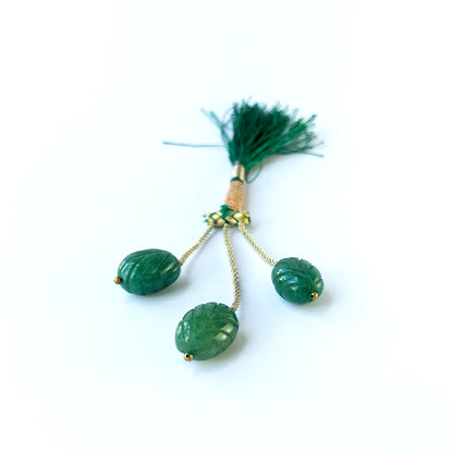 Handmade jewellery components featuring natural emerald carved oval beads in a matched trio.