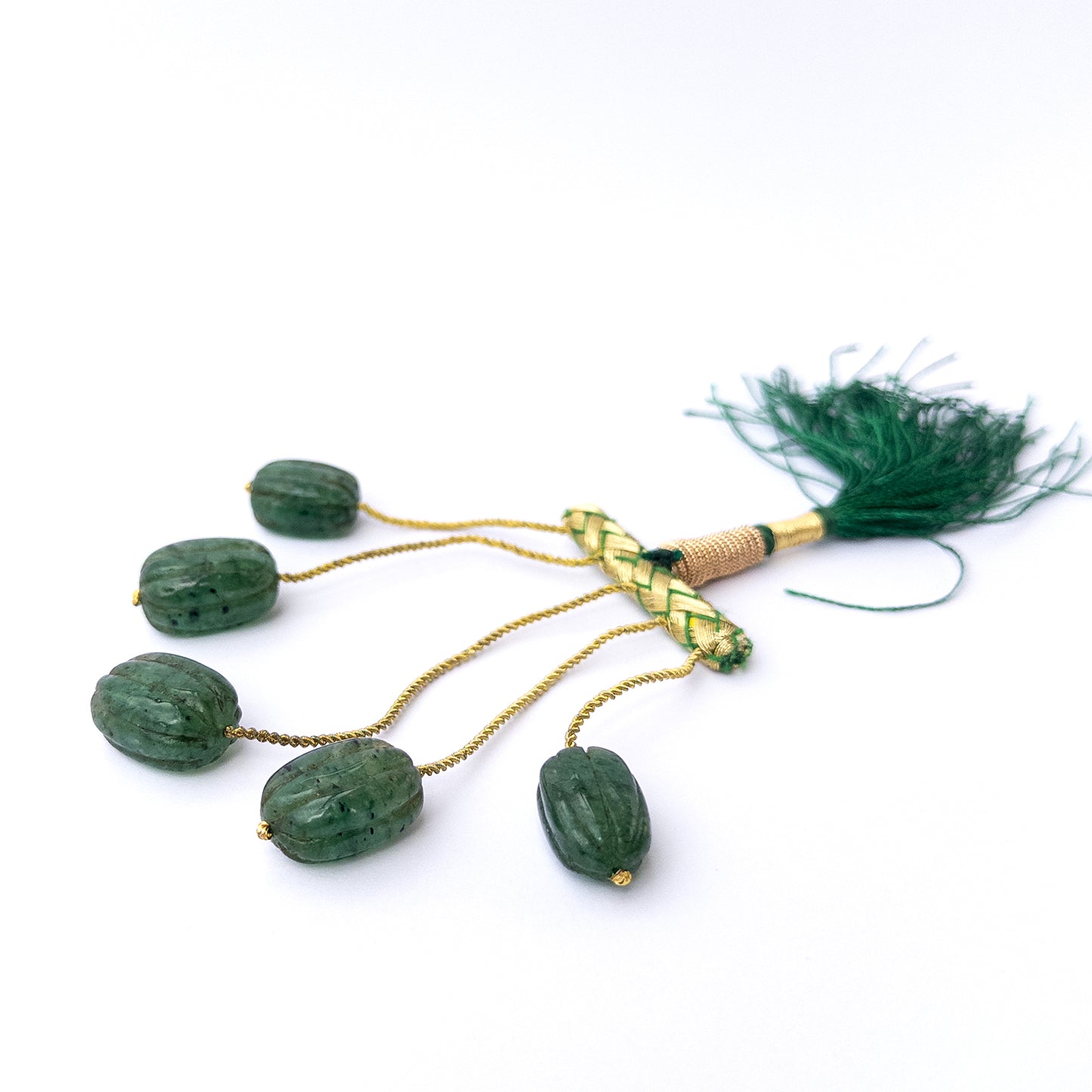 Handmade jewellery components featuring natural emerald carved oval beads in a matched five‑piece group.