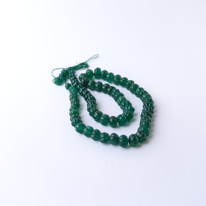 Authentic Emerald stone beads showcasing rich colour and carved pumpkin texture for jewellery designers.