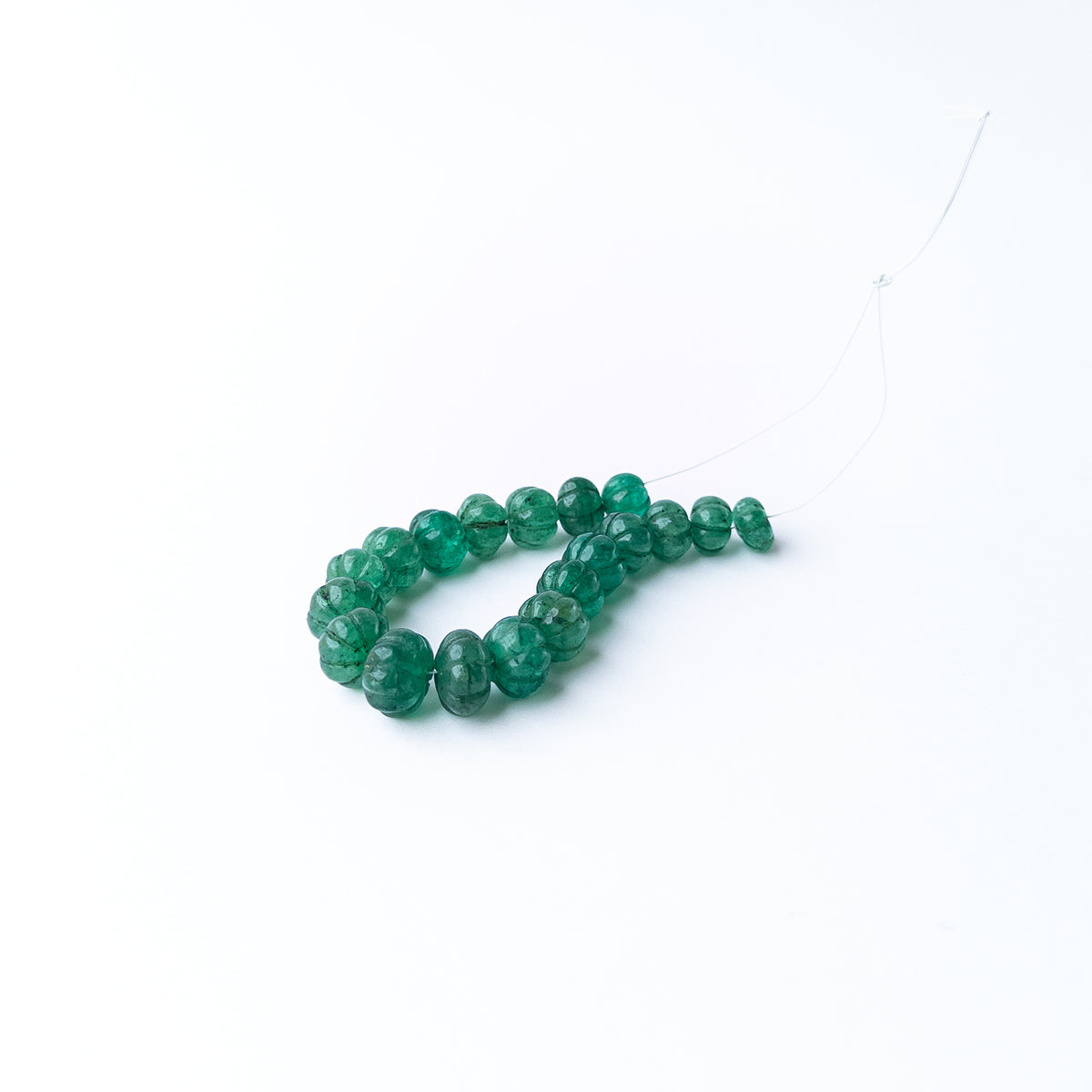 Authentic Emerald stone beads featuring carved pumpkin shapes that add texture and elegance to handmade jewellery designs.
