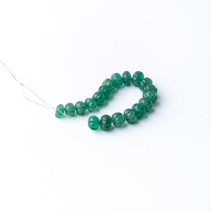 High quality Emerald stone beads featuring artistic carving details and vibrant colour for statement designs.