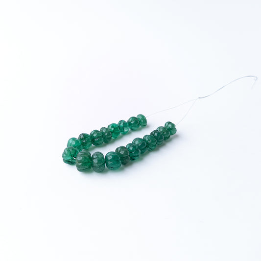 Emerald carved pumpkin gemstone beads showcasing vibrant green hues with detailed carving and exceptional gemstone character.