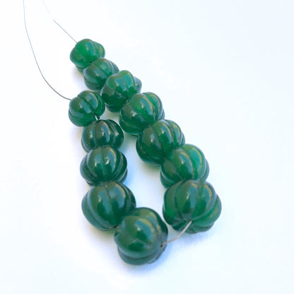  Stone beads showcasing carved pumpkin detailing and vibrant emerald colour. 