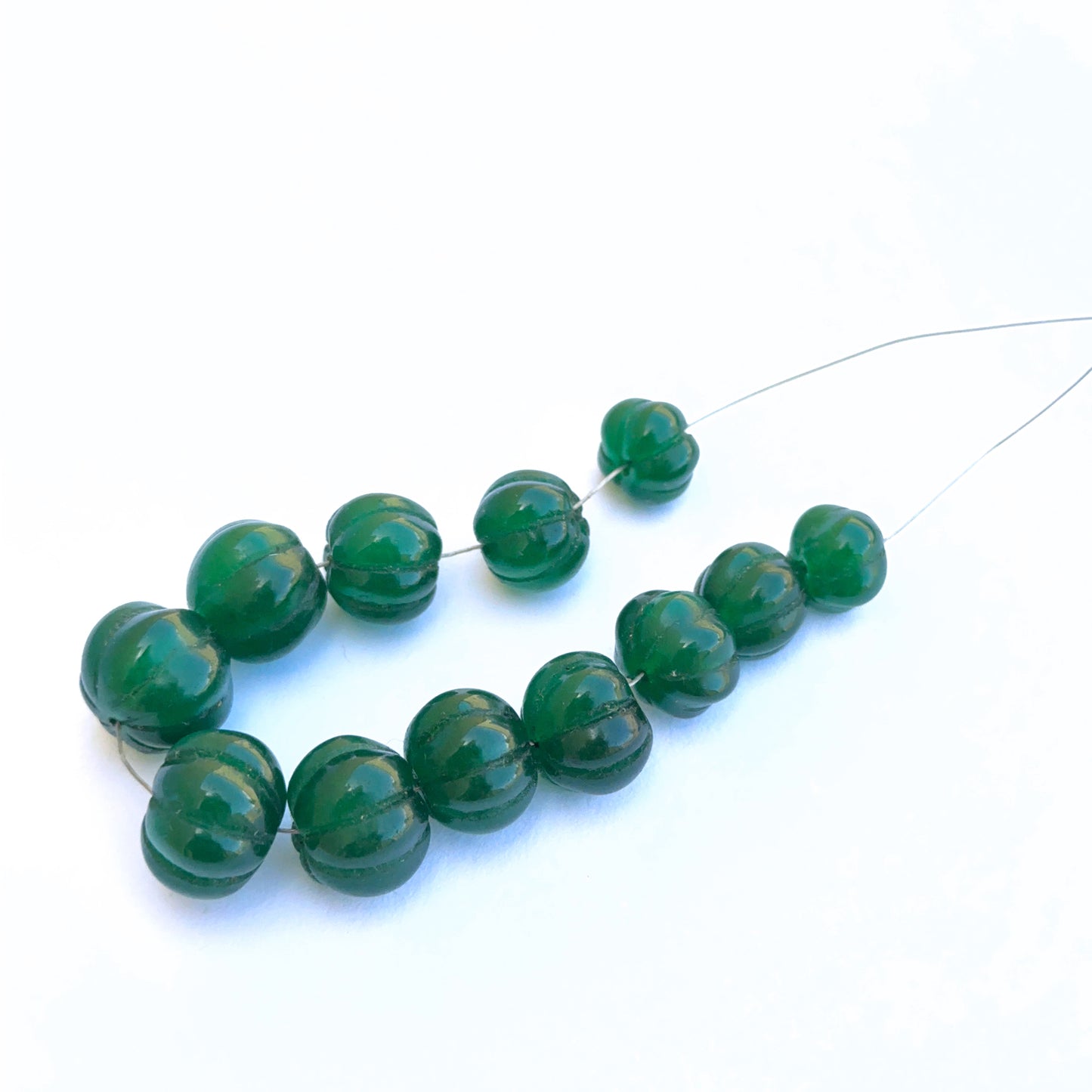 Close-up of gemstone beads highlighting carving and polished texture.