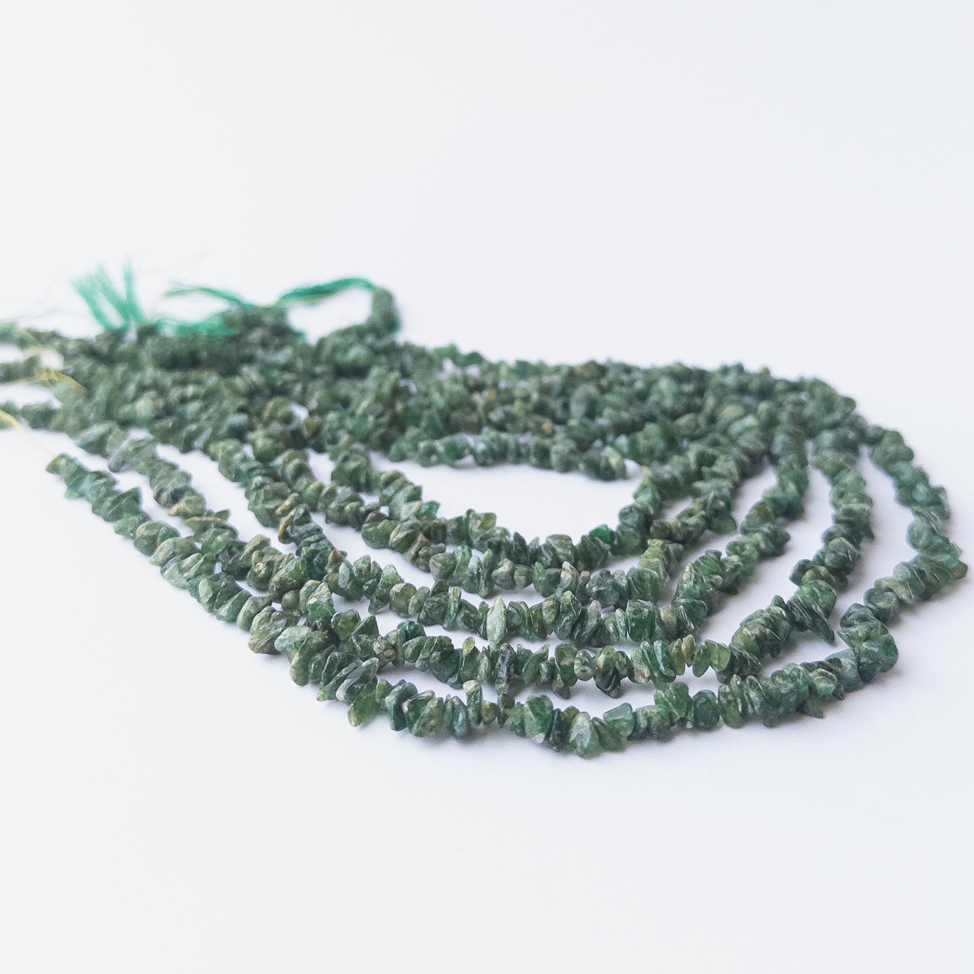 Authentic Shaded Emerald gemstone chips with rich green tones, ideal for DIY jewellery and beadwork.