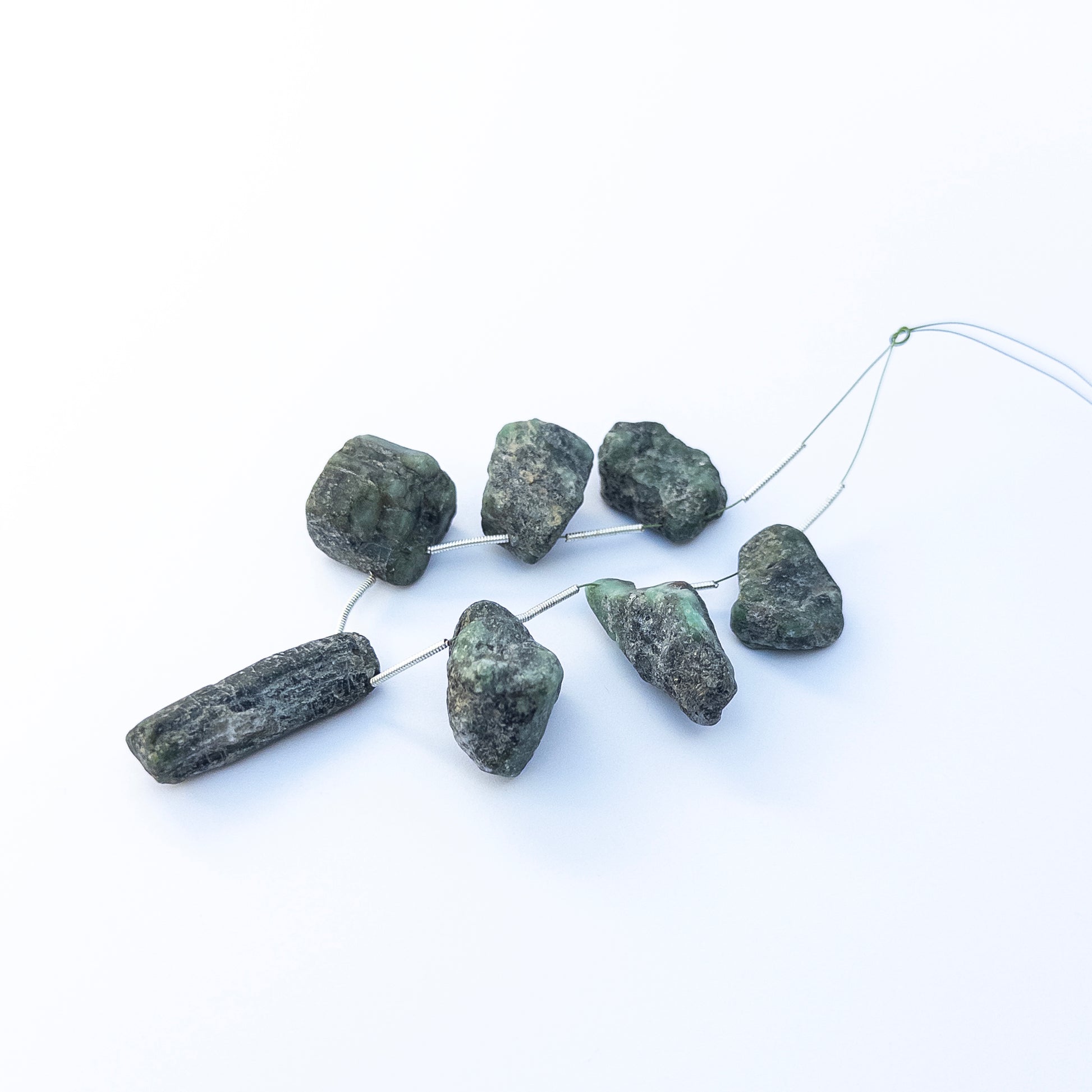 Authentic Emerald drilled rough stone beads for DIY jewellery, displaying bold earthy colour and organic crystal form.