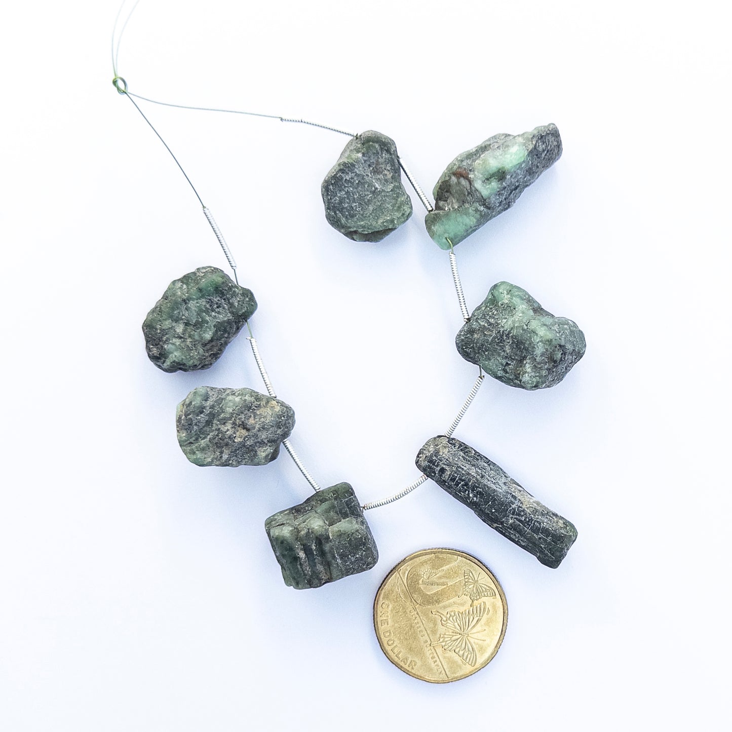 High‑quality Emerald stone beads in drilled rough form, perfect for DIY jewellery makers seeking bold organic style.