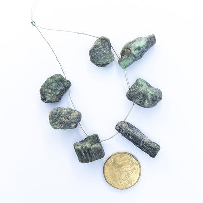 High‑quality Emerald stone beads in drilled rough form, perfect for DIY jewellery makers seeking bold organic style.