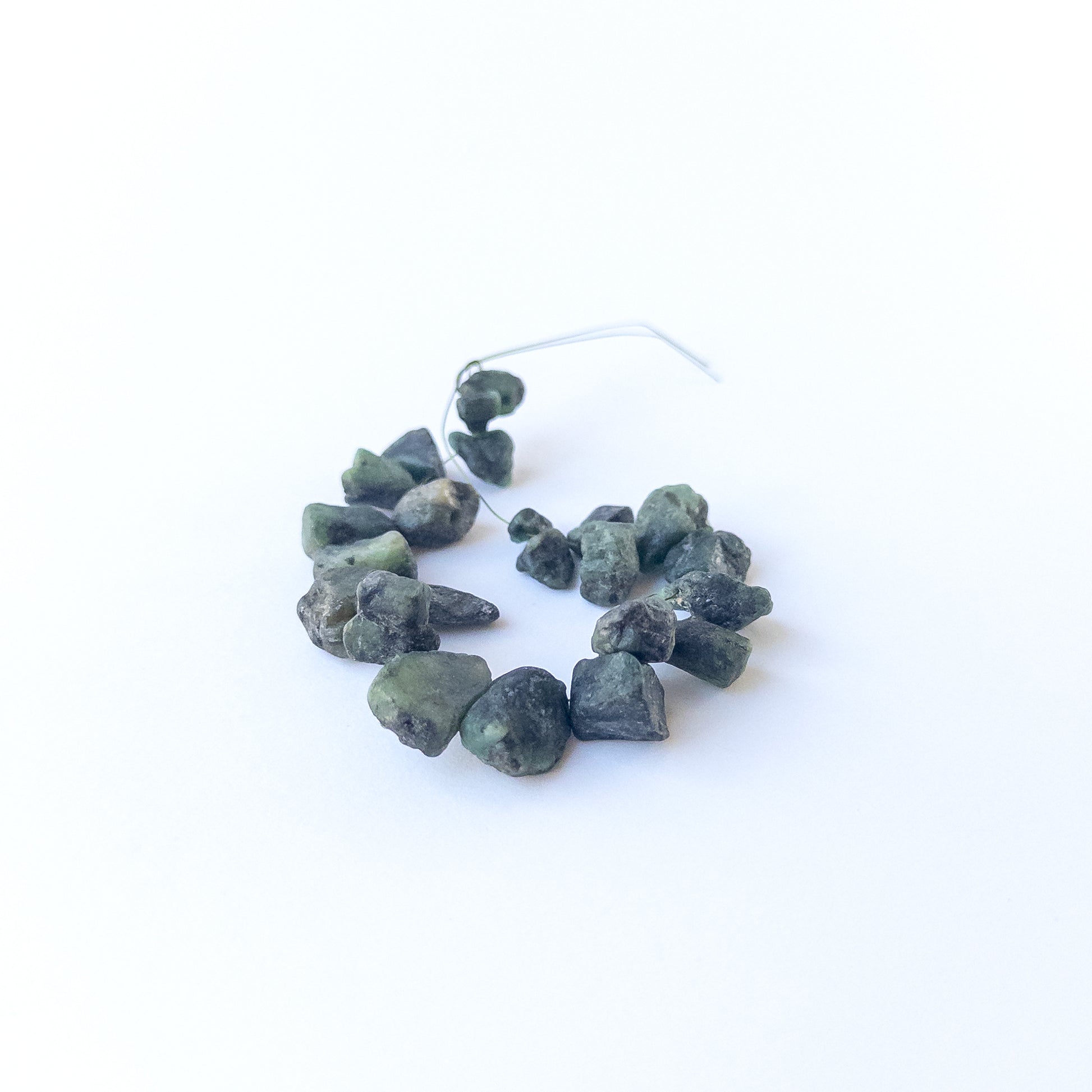 Emerald drilled rough gemstone beads in natural green tones, ideal for genuine stone bead jewellery making.