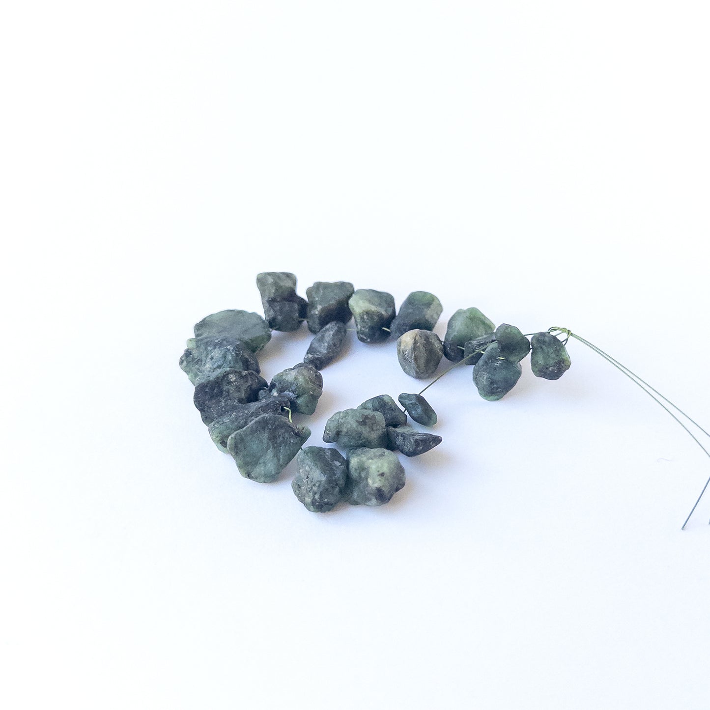 Genuine Emerald gemstone beads showcasing raw crystal form, earthy texture and handmade jewellery quality.
