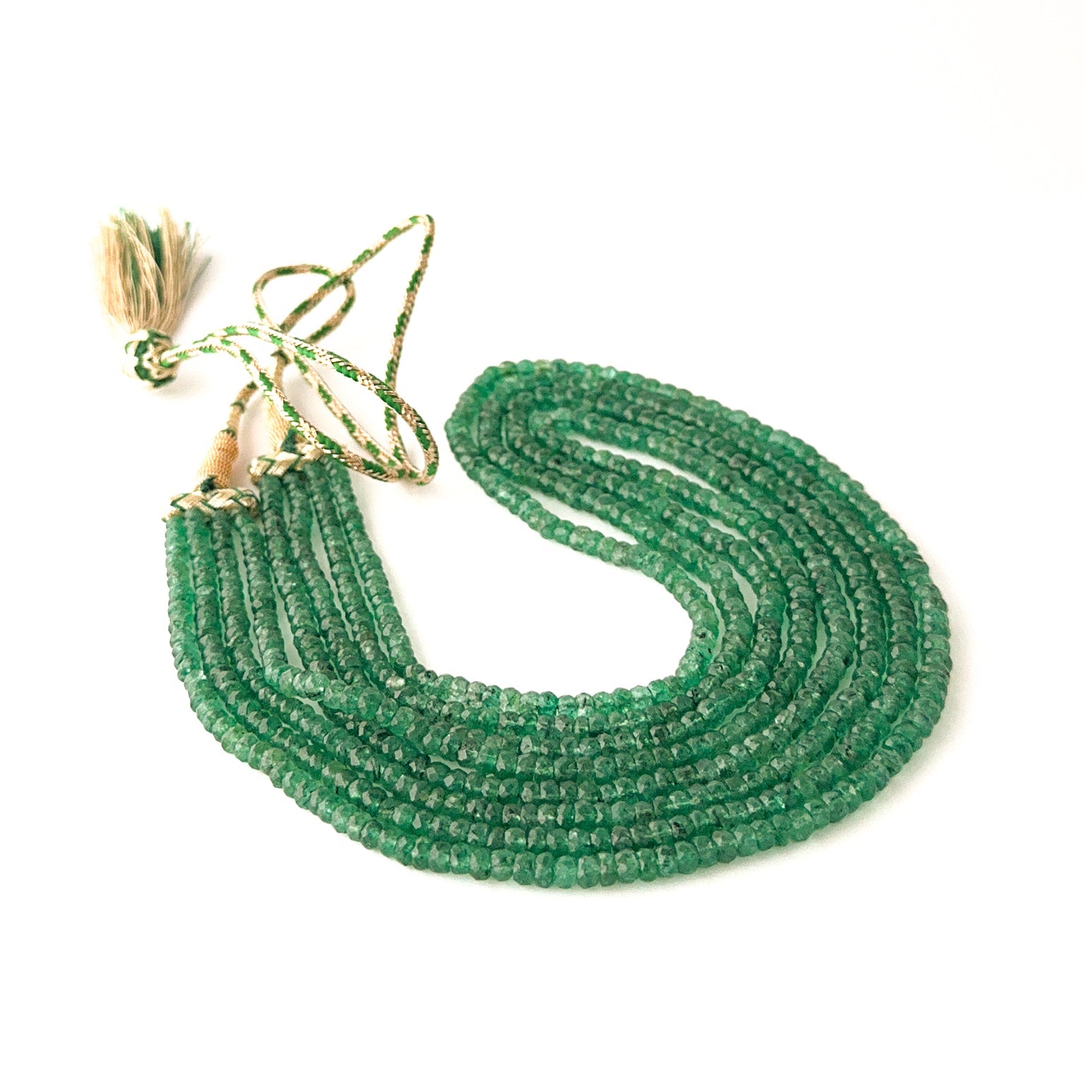 Layered emerald necklace showcasing faceted rondelle beads in four strands of graduated lengths.