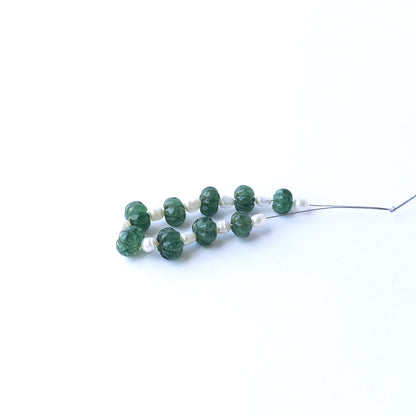 Authentic emerald and freshwater pearl beads showcasing rich green tones and lustrous white accents.