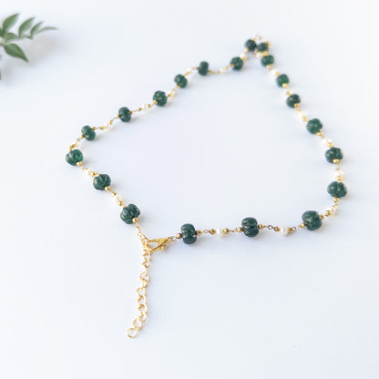 Genuine gemstone beads in Emerald and Pearls showing carved shine and quality craftsmanship in a necklace design.