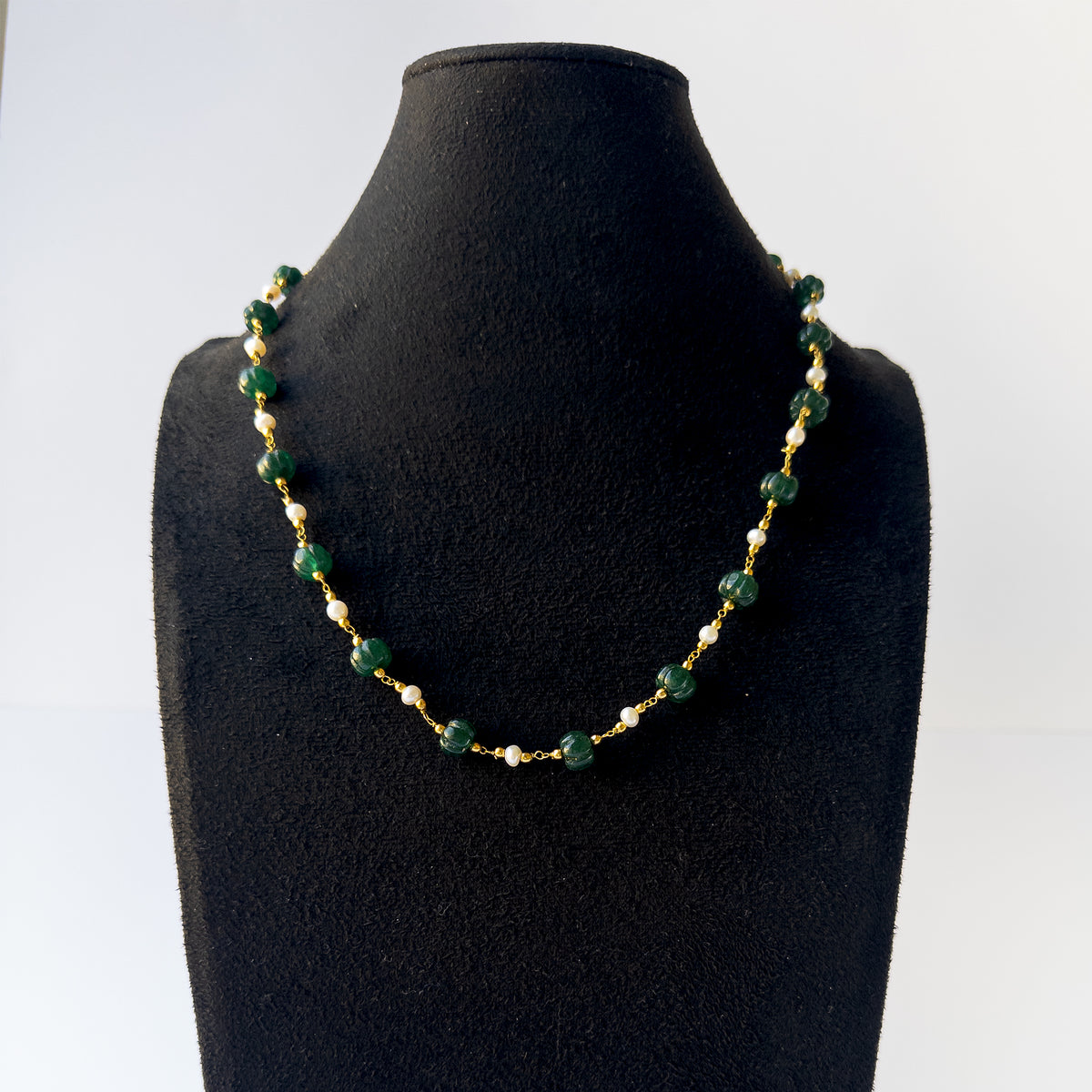 Authentic Emerald and Pearl gemstone necklace displaying natural colour, sculpted detailing, and premium clarity.