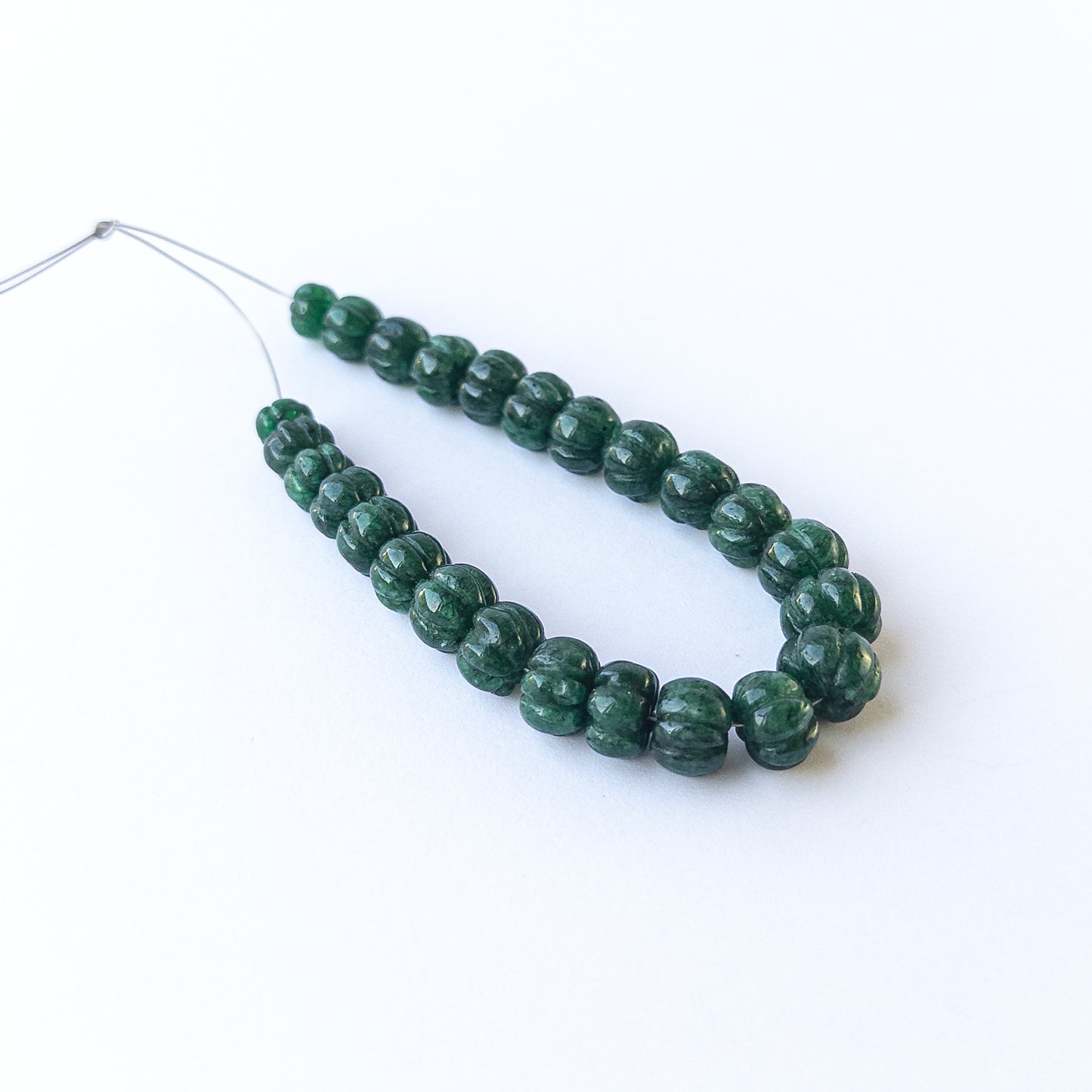 Emerald pumpkin‑cut gemstone beads in 6.8–10mm sizes, showcasing rich green colour for handmade jewellery designs.