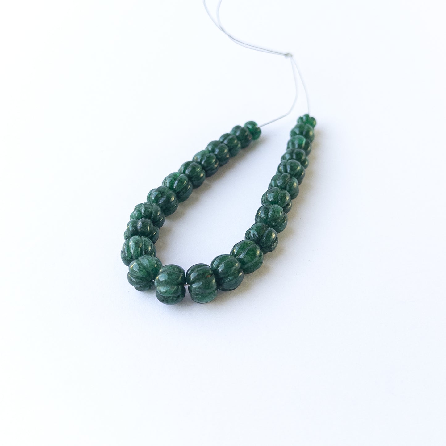 Genuine emerald stone beads with carved pumpkin cut, ideal for DIY jewellery and artisan gemstone beadwork.