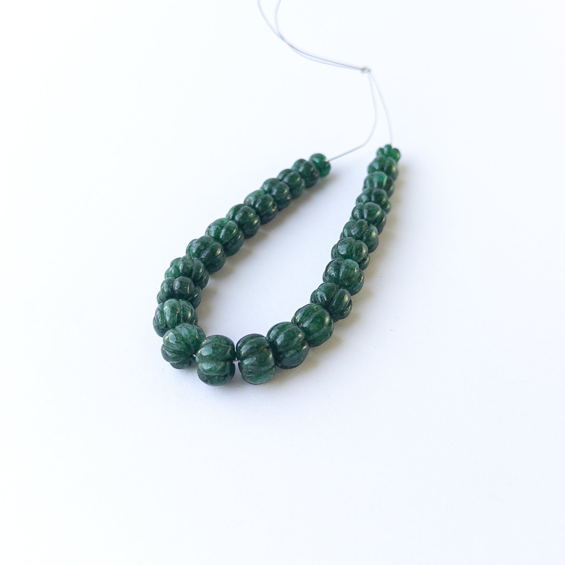 Genuine emerald stone beads with carved pumpkin cut, ideal for DIY jewellery and artisan gemstone beadwork.