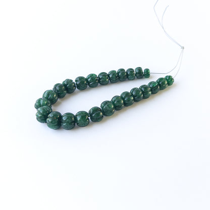 Authentic emerald gemstone beads featuring deep green tones and textured pumpkin carving for premium jewellery.