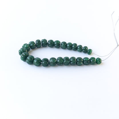 Handmade jewellery components with natural emerald pumpkin‑cut beads arranged in a 25‑piece set.