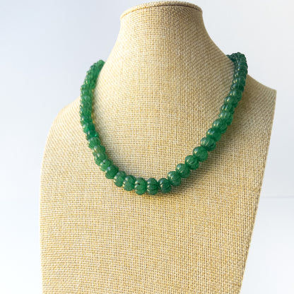 Authentic Emerald gemstone necklace displaying natural colour, carved detailing, and premium clarity.