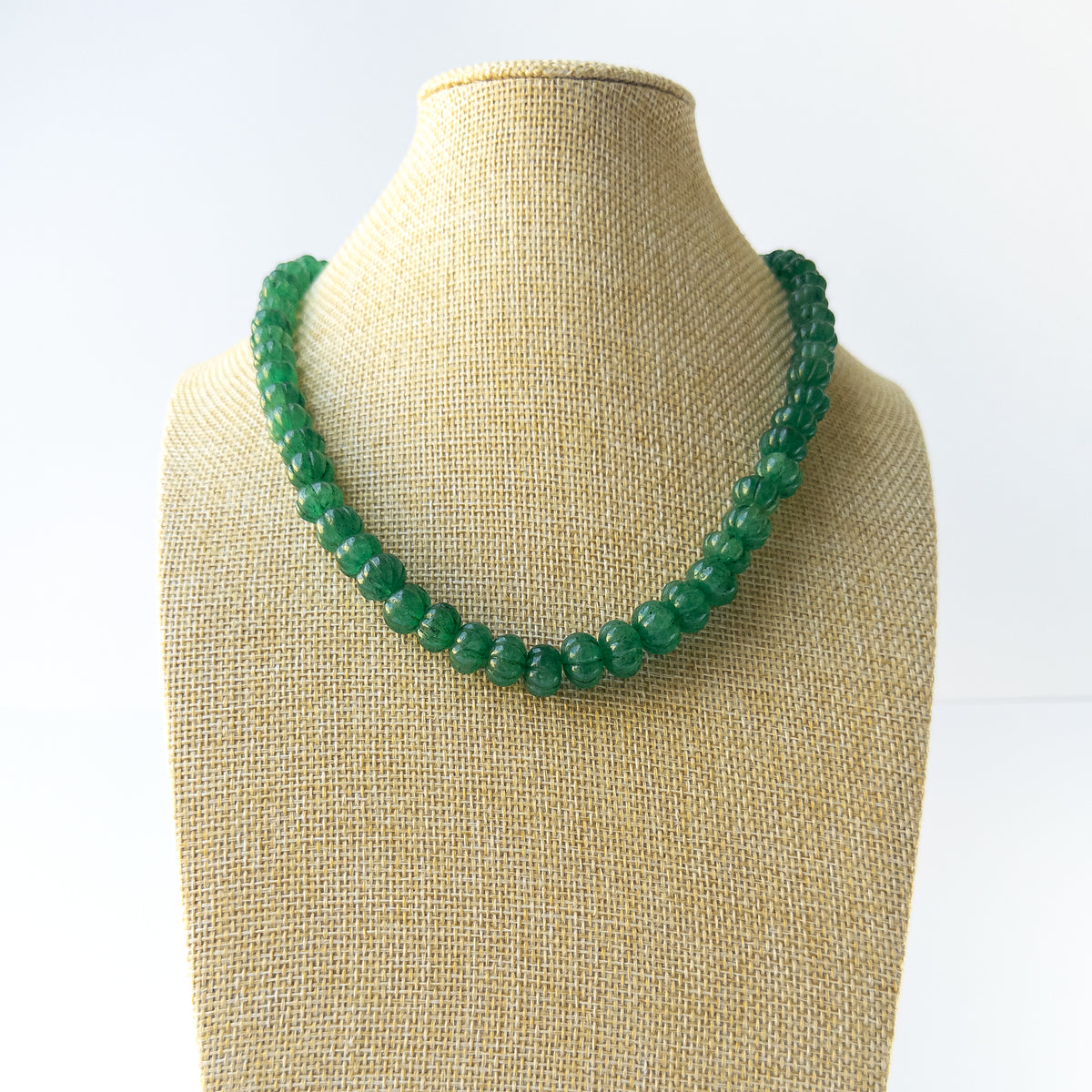 Genuine Emerald stone beads with sculpted pumpkin‑cut texture arranged in an elegant necklace.