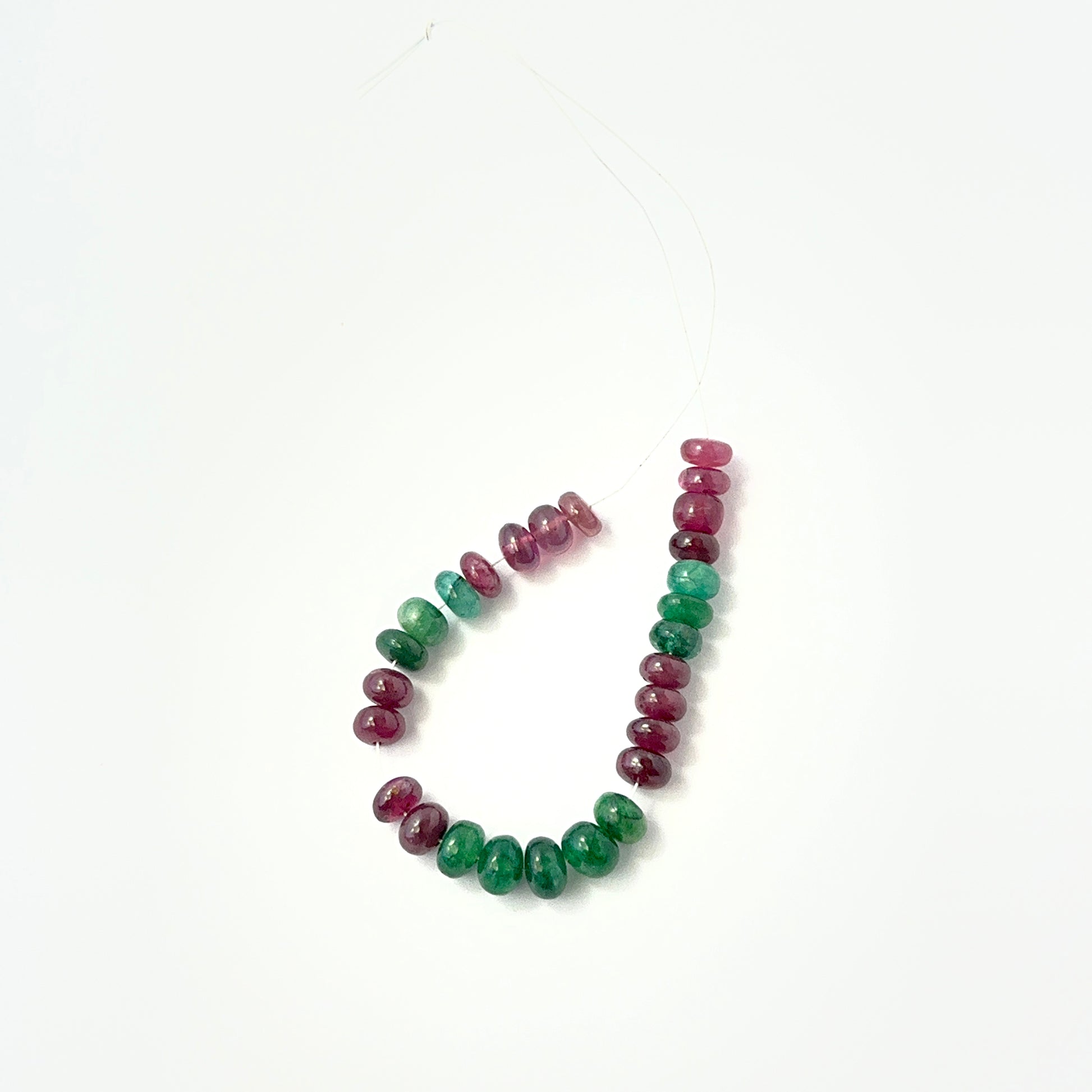 Emerald and Ruby smooth rondelle beads in rich green and red tones, ideal for genuine gemstone beads in DIY jewellery.