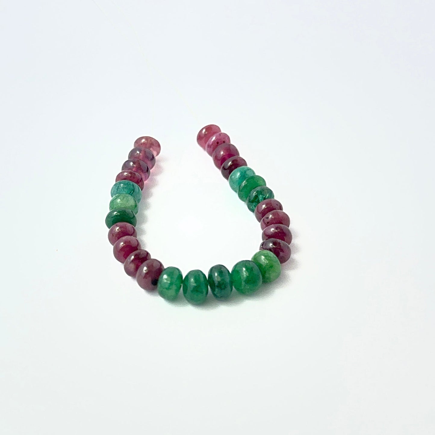 Polished Emerald and Ruby rondelle‑cut beads with soft shine, perfect for authentic gemstone beads in creative designs.