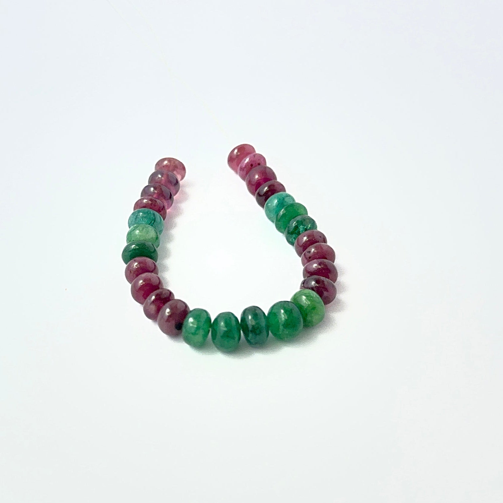Polished Emerald and Ruby rondelle‑cut beads with soft shine, perfect for authentic gemstone beads in creative designs.