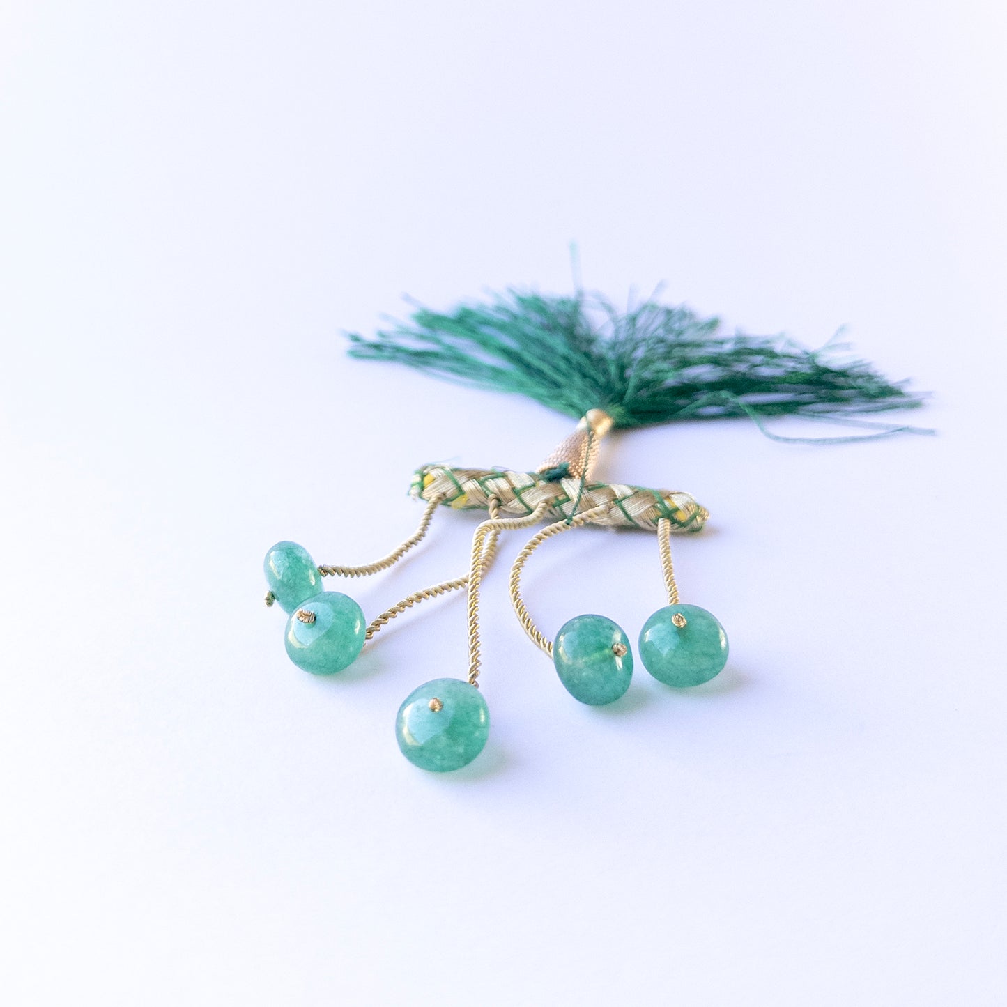 Emerald smooth rondelle beads in 10–10.7mm size arranged in a small set, showing rich green tones for handmade jewellery components.