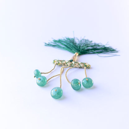 Emerald smooth rondelle beads in 10–10.7mm size arranged in a small set, showing rich green tones for handmade jewellery components.