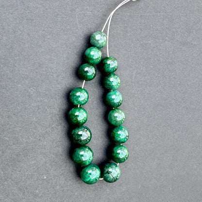 Emerald smooth rondelle beads in 8-9mm size with polished finish and rich green tones for handmade jewellery components.