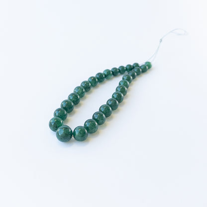 Genuine Emerald smooth round gemstone beads showcasing rich green colour and polished shine.