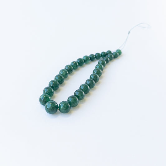 Genuine Emerald smooth round gemstone beads showcasing rich green colour and polished shine.