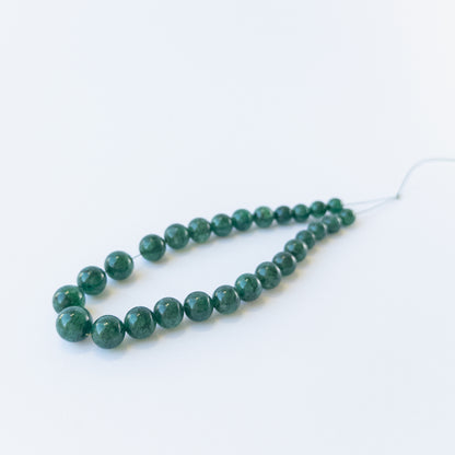 Emerald gemstone beads for jewellery design showing glossy surfaces and natural clarity.