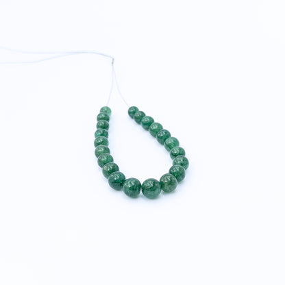 Authentic Emerald smooth round stone beads for DIY jewellery, displaying natural colour and fine craftsmanship.
