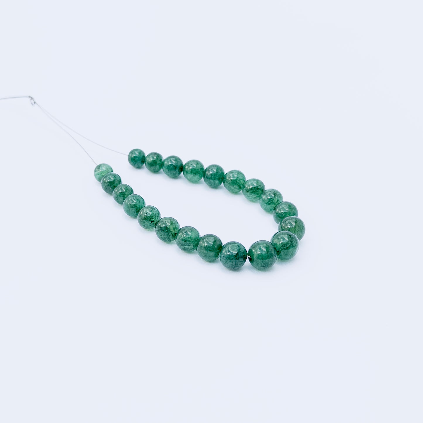 Genuine Emerald smooth round beads with deep green hues, ideal for handmade jewellery components.