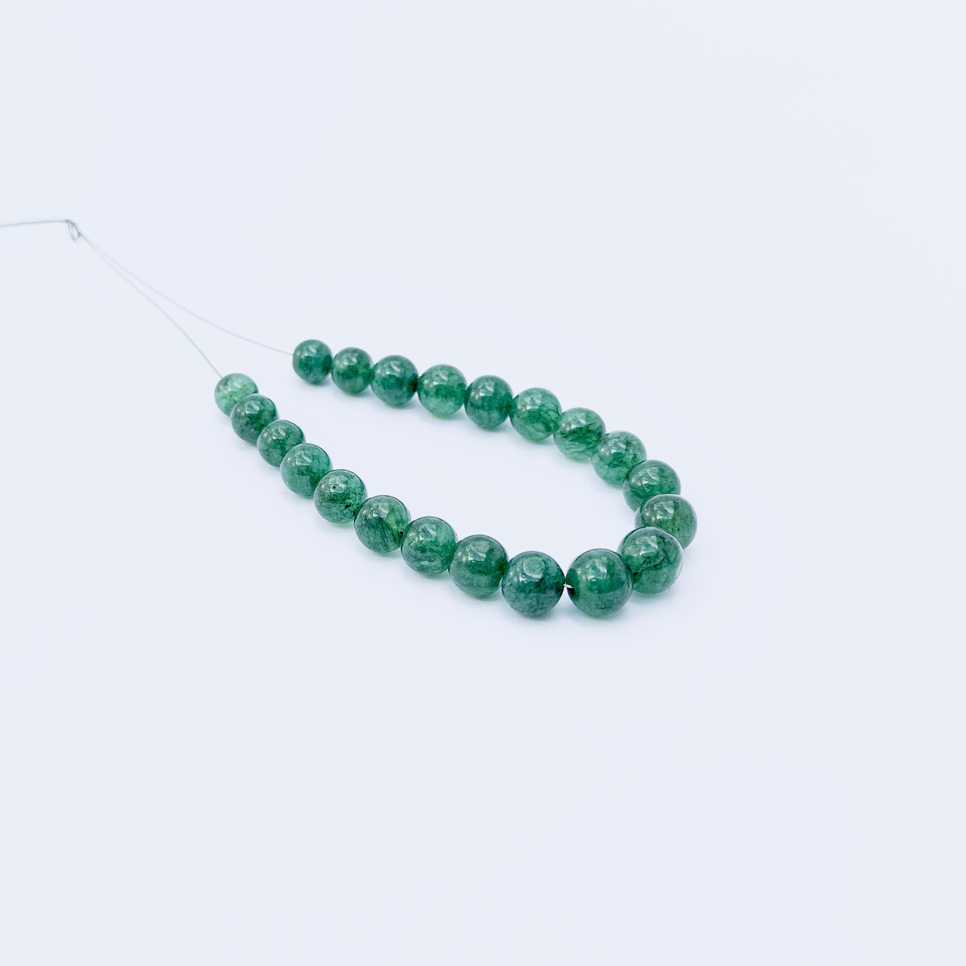 Genuine Emerald smooth round beads with deep green hues, ideal for handmade jewellery components.