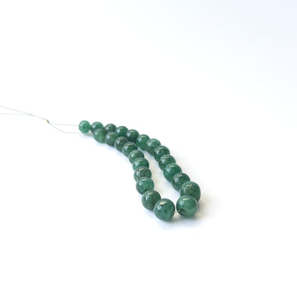 Authentic Emerald gemstone beads featuring polished smooth round cuts ideal for DIY jewellery making.