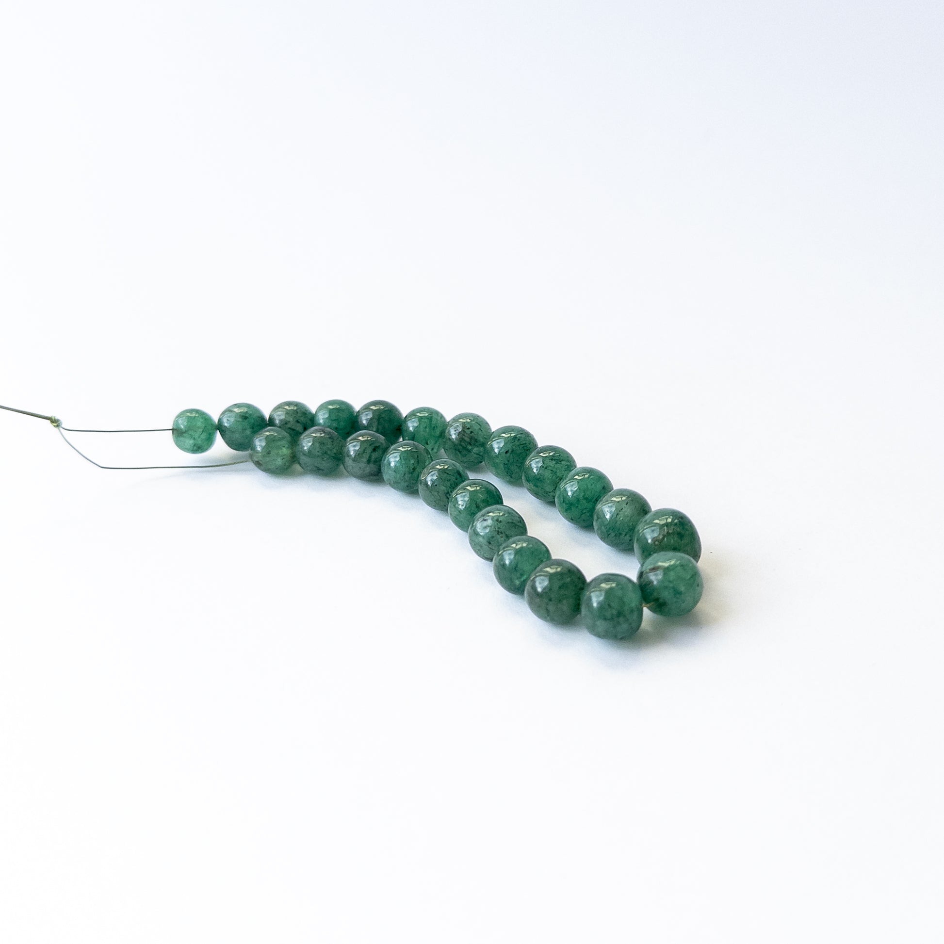 Natural Emerald stone beads with rich green tones and smooth round shapes, perfect for artisan jewellery.