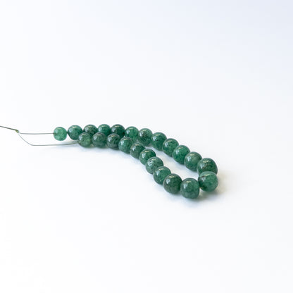 Natural Emerald stone beads with rich green tones and smooth round shapes, perfect for artisan jewellery.