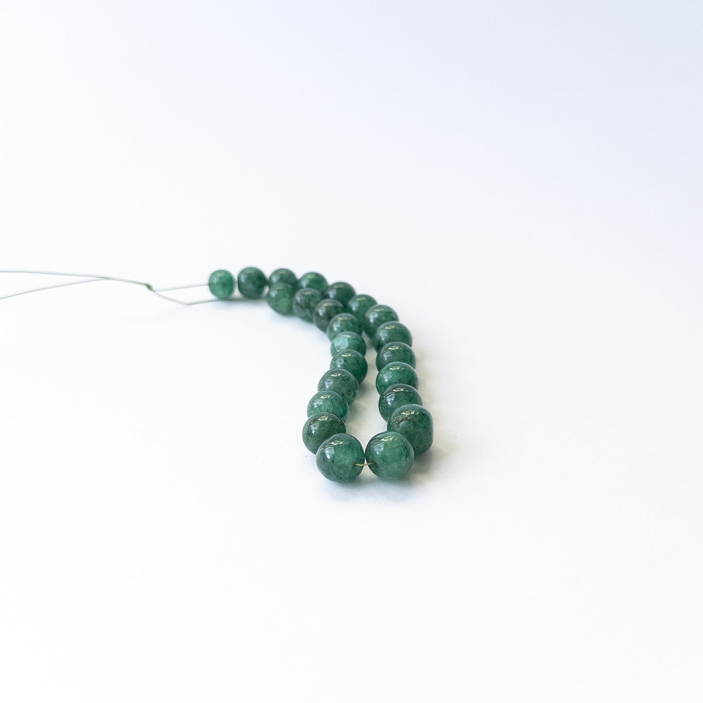 Emerald smooth round gemstone beads in 7–9mm sizes, genuine stones for handmade jewellery.