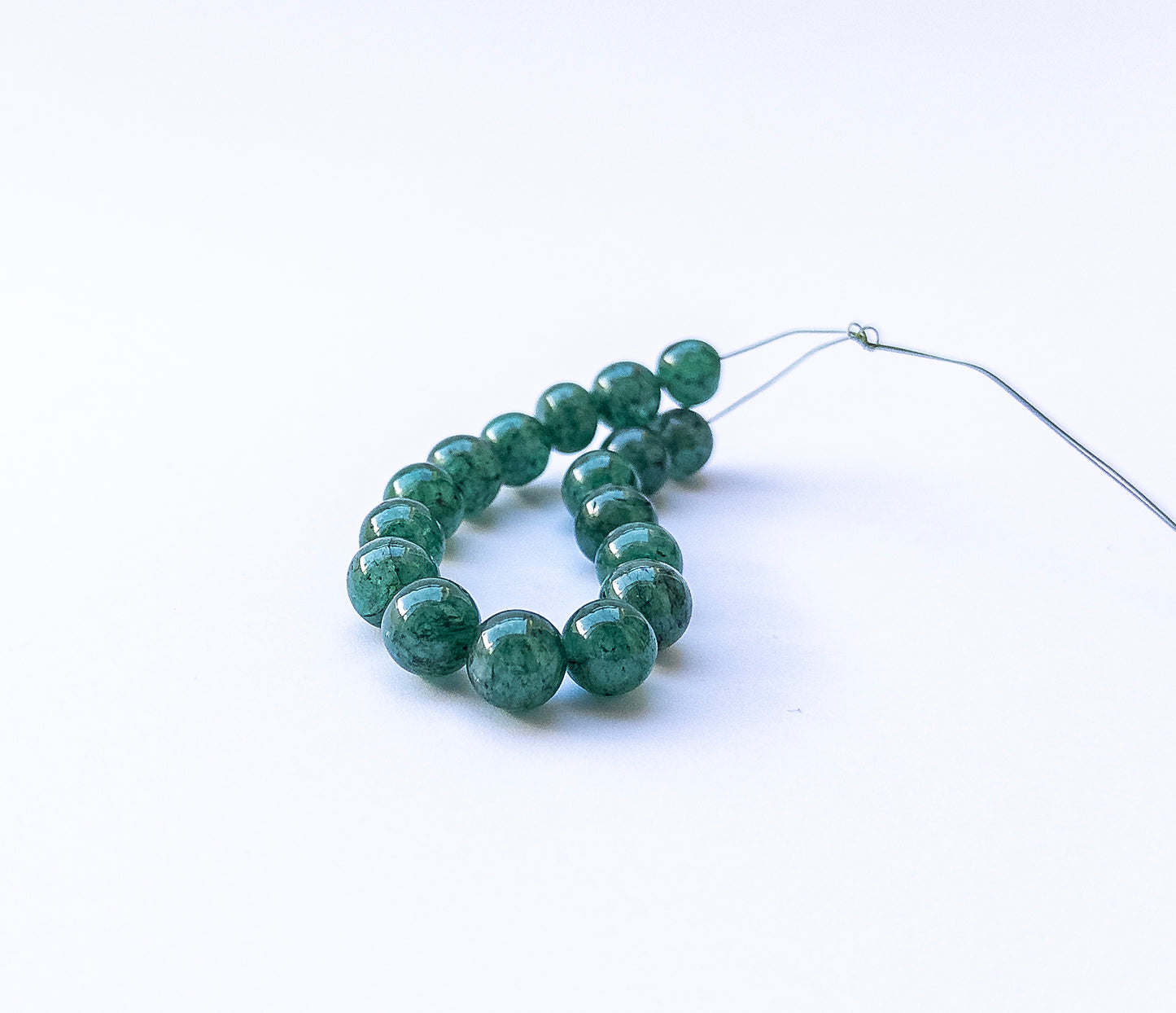 High‑quality Emerald round beads displaying bold colour and smooth finish.