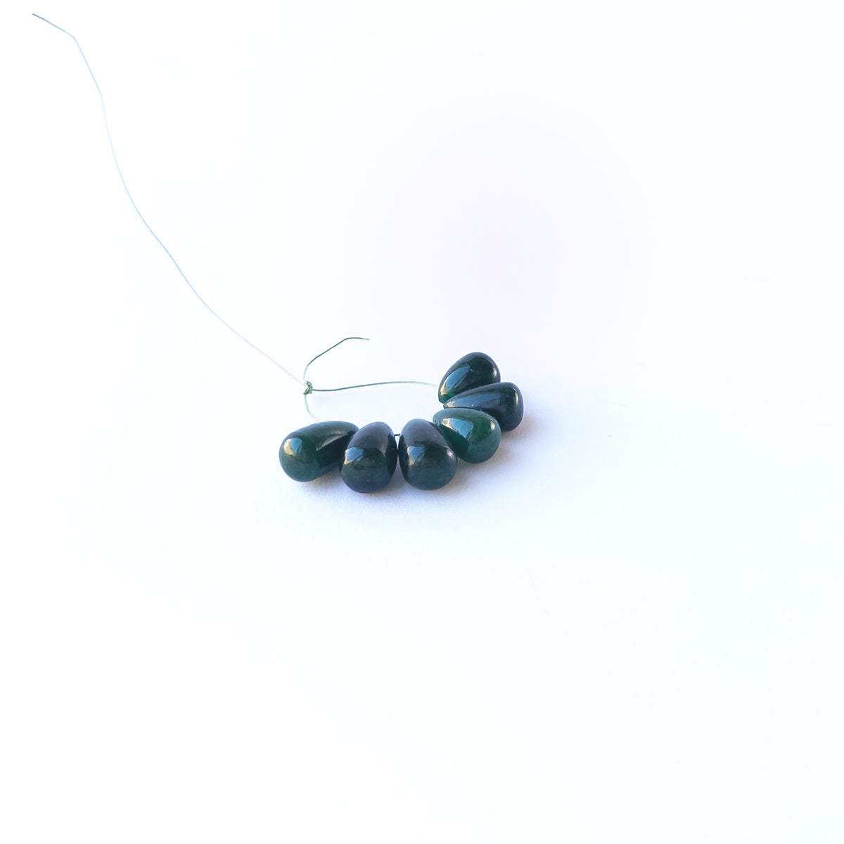 Authentic Emerald briolette beads with polished teardrop‑style shaping and natural colour variation.