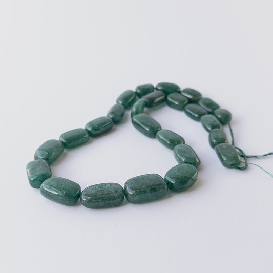 Rich green Emerald smooth tumble beads arranged in a 50cm strand for handmade gemstone jewellery making.