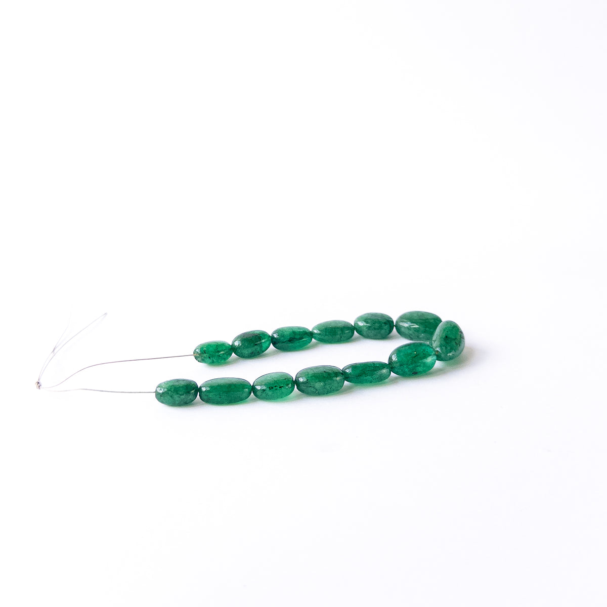 Smooth tumble Emerald beads in assorted 6.8–8.5mm sizes for artisan jewellery components.