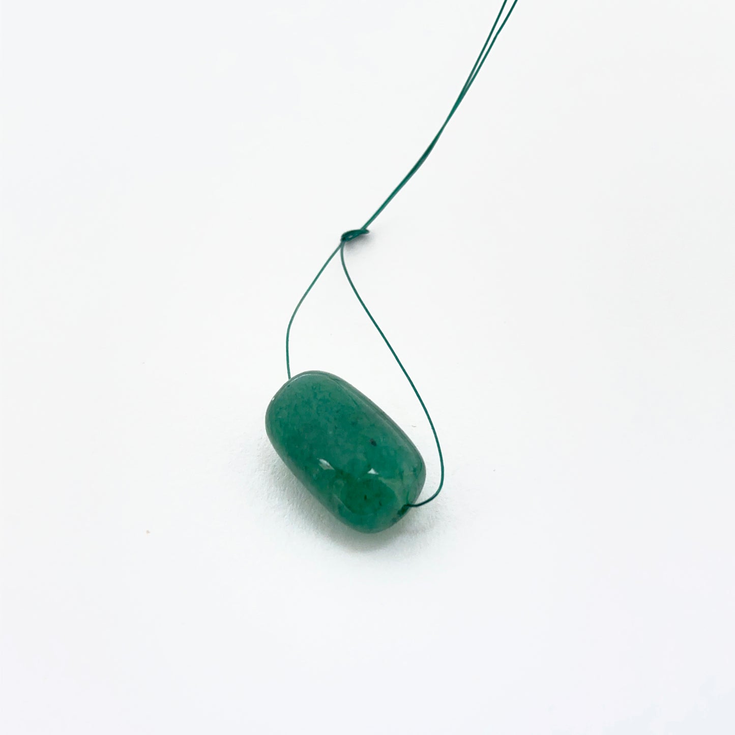 Emerald tumble-drilled gemstone showing rich green colour and texture for handmade jewellery.
