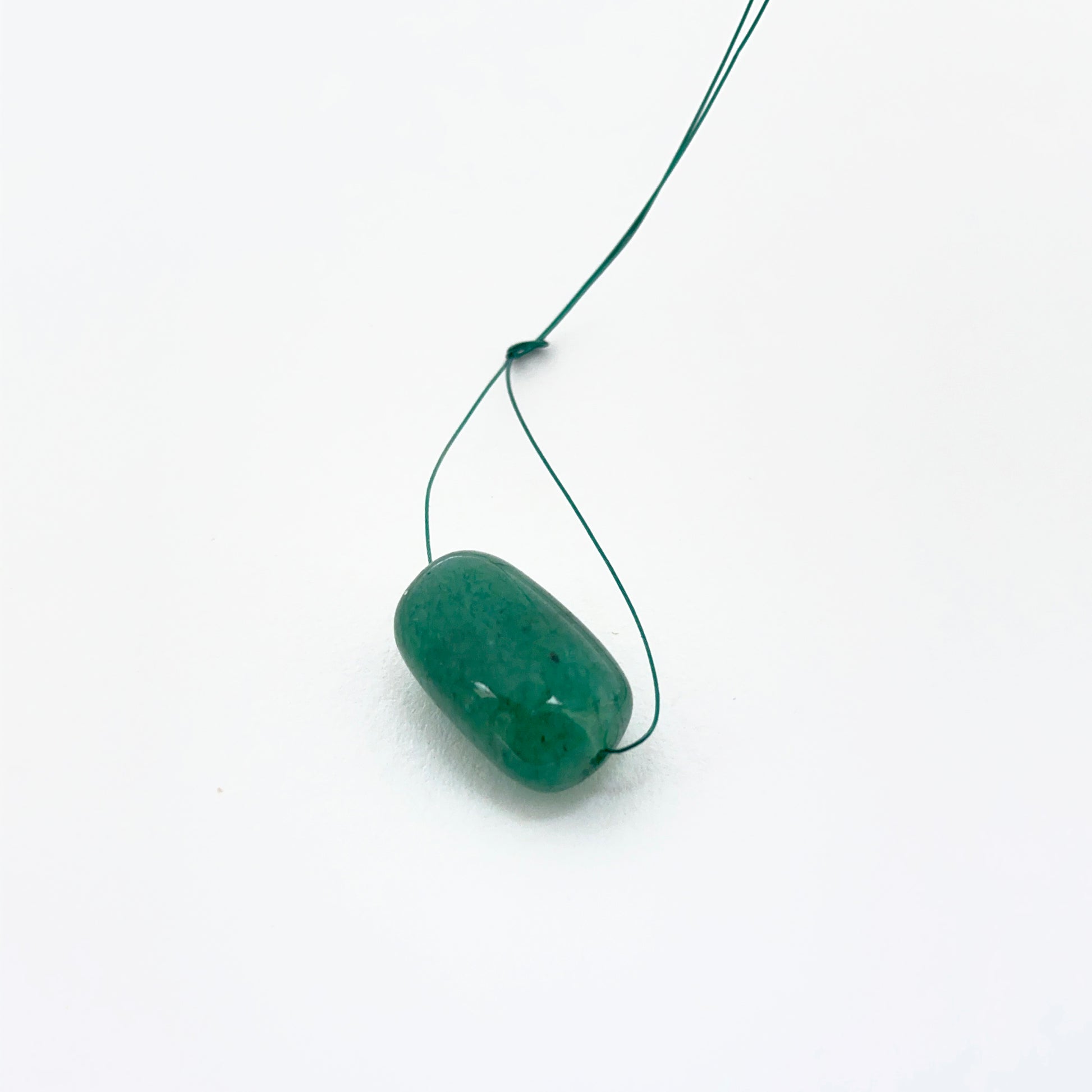 Emerald tumble-drilled gemstone showing rich green colour and texture for handmade jewellery.