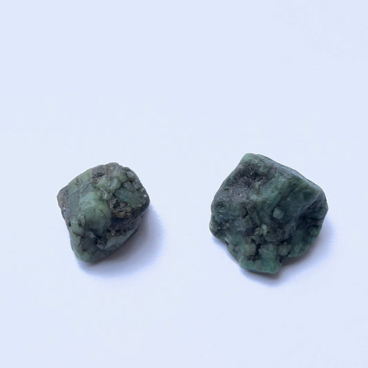 Close up of undrilled emerald rough on a white background.